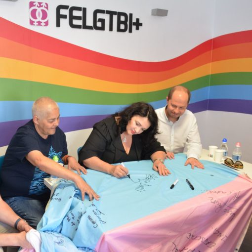 Helena Dalli firma la bandera trans